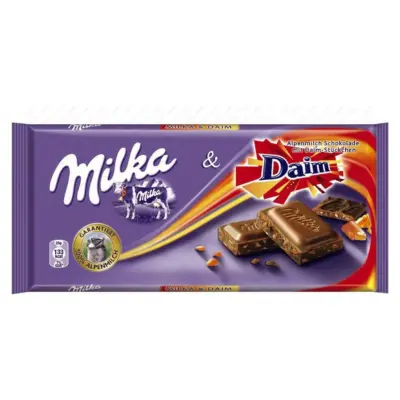 Шоколад молочний з карамеллю і мигдалем Milka Ganze Hazelnuts Швейцарія 100 г